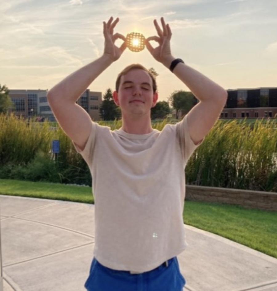 Me holding a waffle fry over my head in the sunset